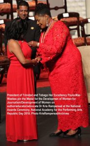 Dr Kris Rampersad receives National Medal for Development of Women Gold from President Paula Mae Weekes